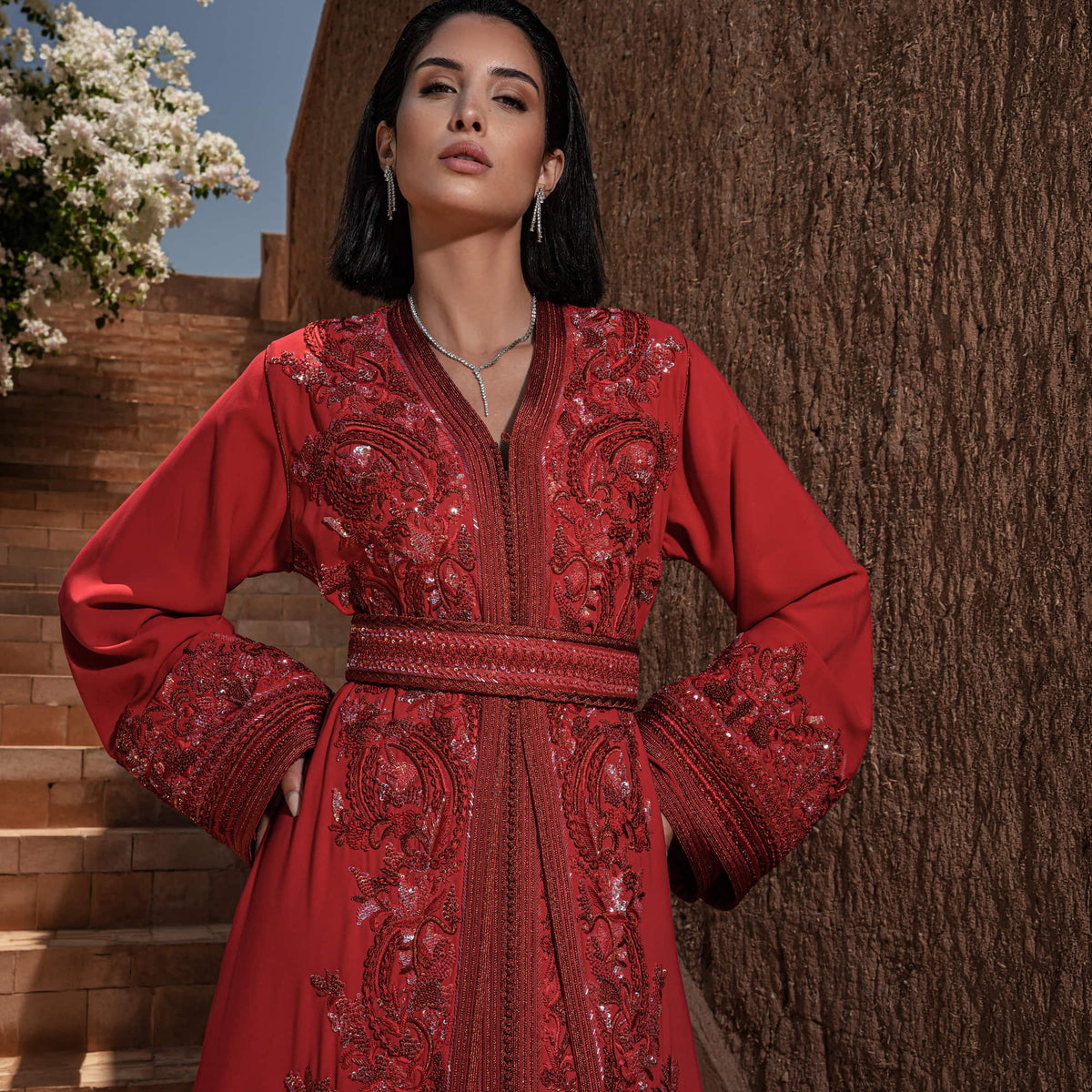 Carmine Cadence red crepe Moroccan kaftan with sequined paisley embroidery, braided belt and flared sleeves