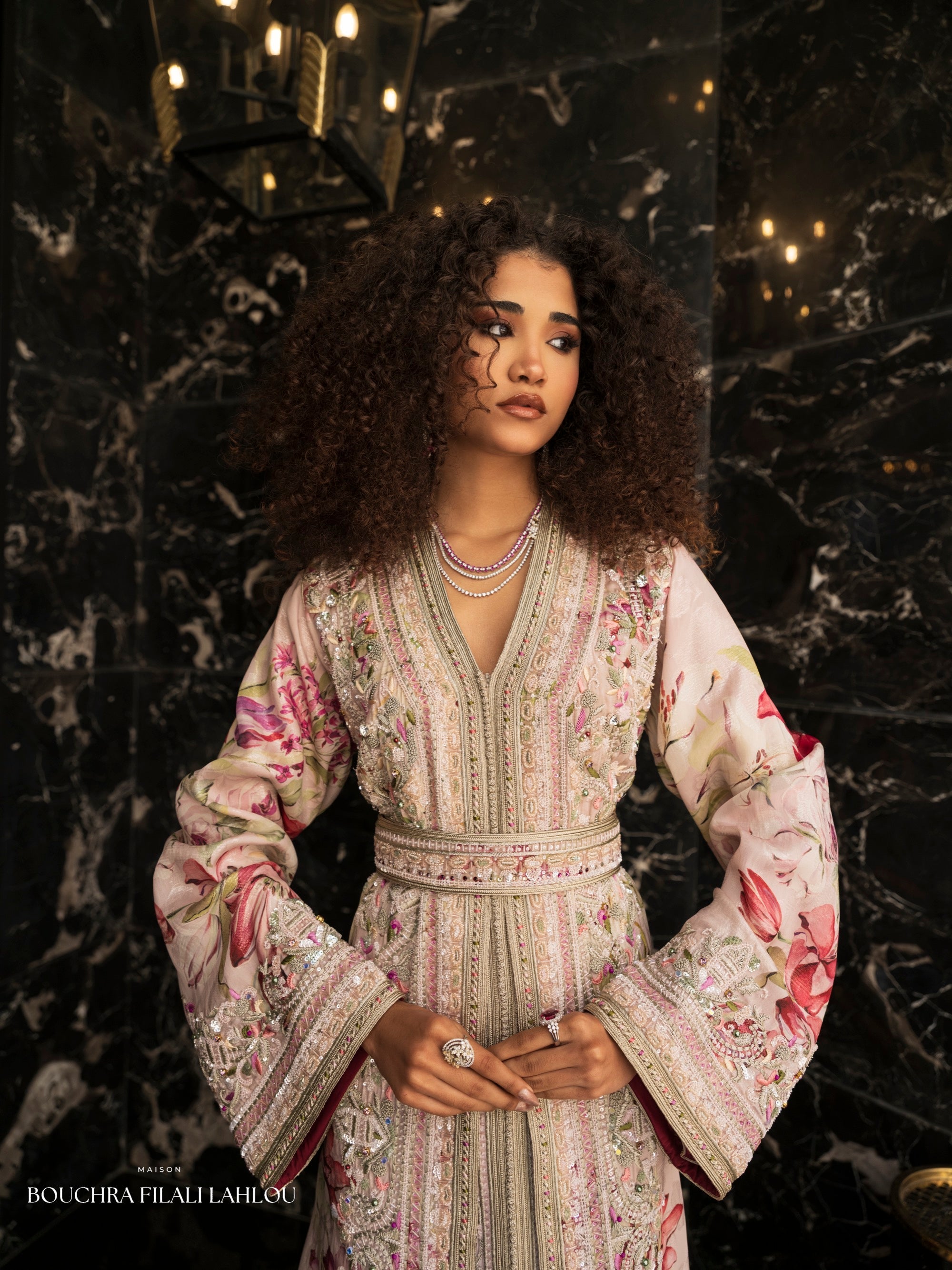 Pale floral Moroccan caftan detail with ornate embroidery and fluid wide sleeves